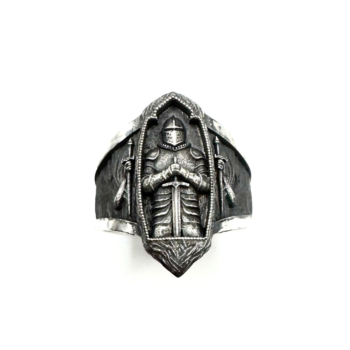 Silver ring with a detailed design on a white background