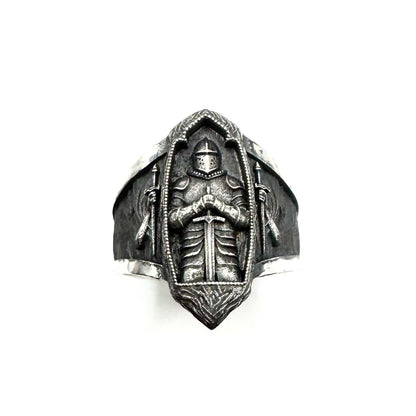 Silver ring with a detailed design on a white background
